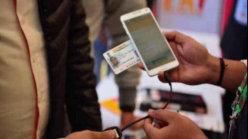 Not asked mobile makers, operators to include helpline number on phones: UIDAI