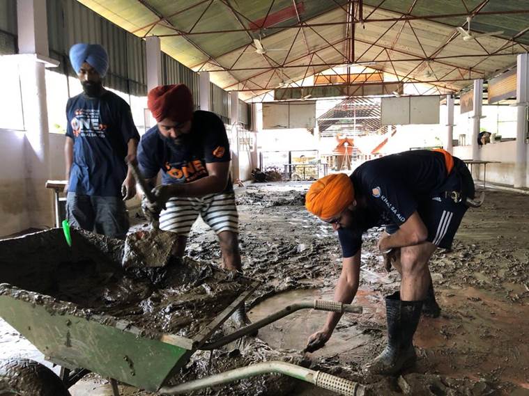 After church, Sikh volunteers from Khalsa Aid take up temple cleaning