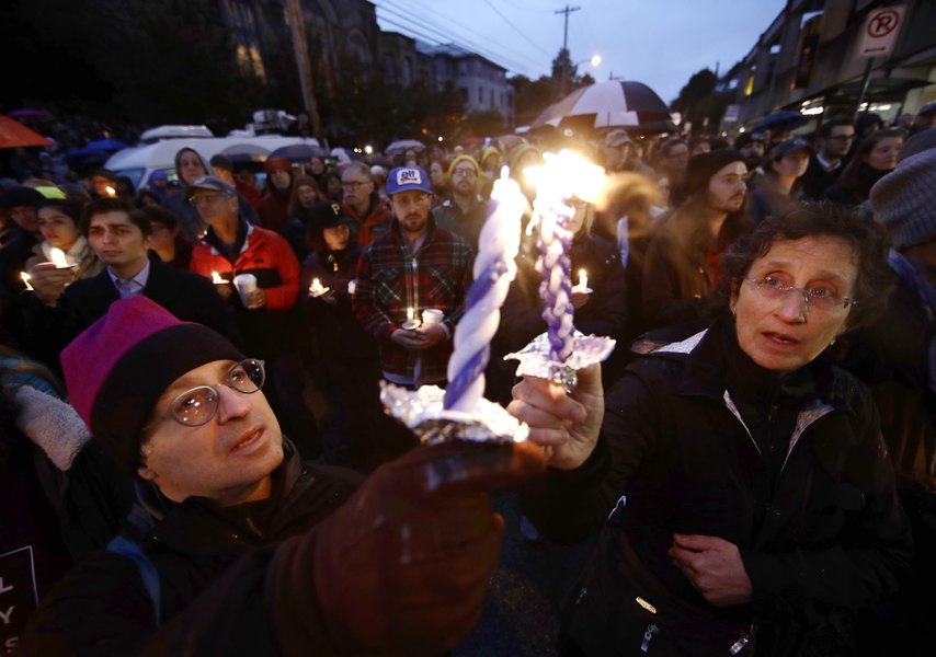 Americans mourn death of 11 people at Pittsburgh synagogue; Suspect charged with 29 counts