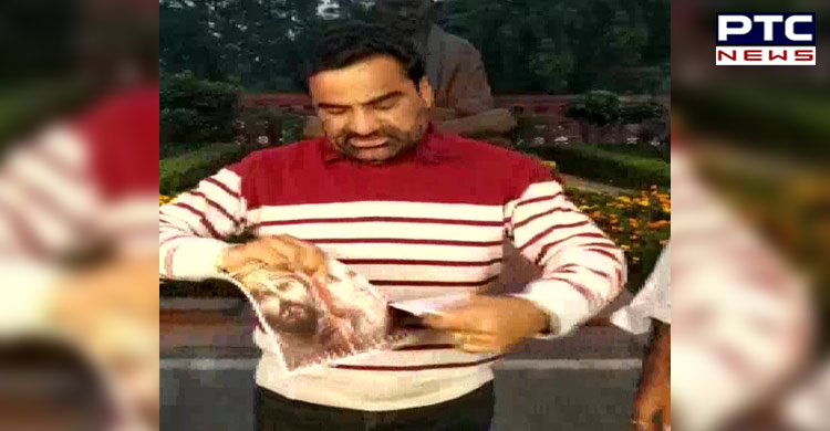 Rajasthan MP Hanuman Beniwal tears the poster of 'Panipat' in protest against the film