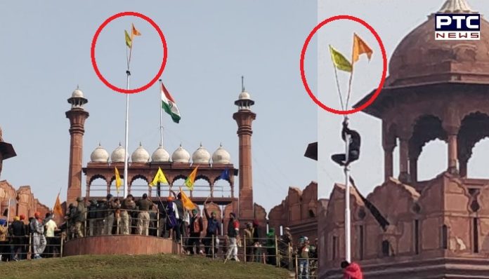 flag at the Red Fort hh Farmers Tractor Parade : Farmers hoist the flag at the Red Fort Delhi