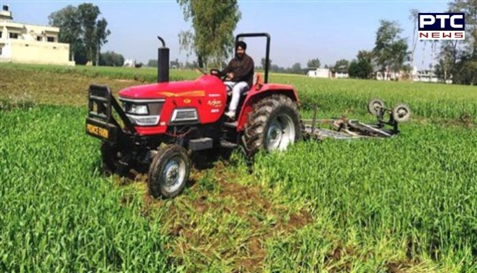 farmer tractor wheat 1 Farmer drives a tractor on a wheat crop in protest of agricultural laws